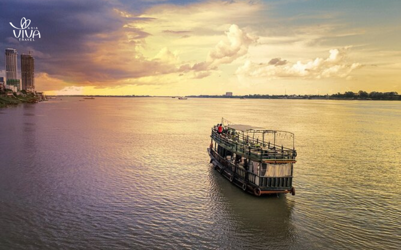 A Mekong Delta river cruise offers a peaceful escape, especially as the sun sets over the tranquil waterways