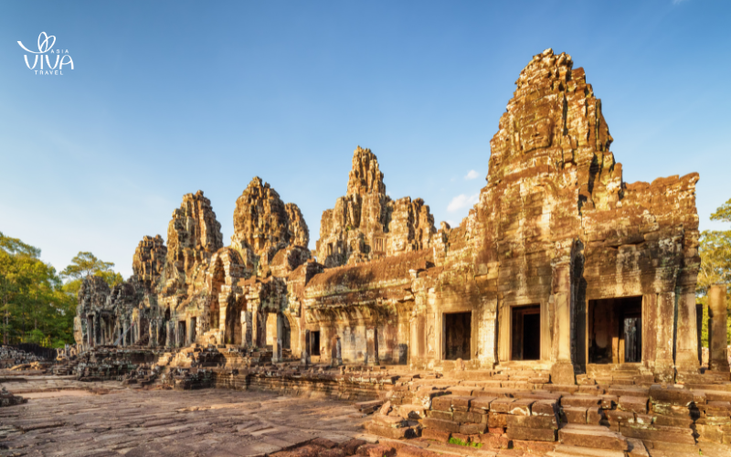 The majestic Angkor Wat at sunrise, showcasing its iconic silhouette and serene reflection in the surrounding moat.