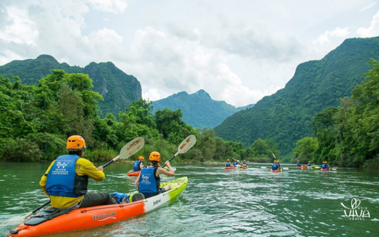 Kayaking through Vang Vieng's crystal-clear waters offers a peaceful yet exhilarating adventure